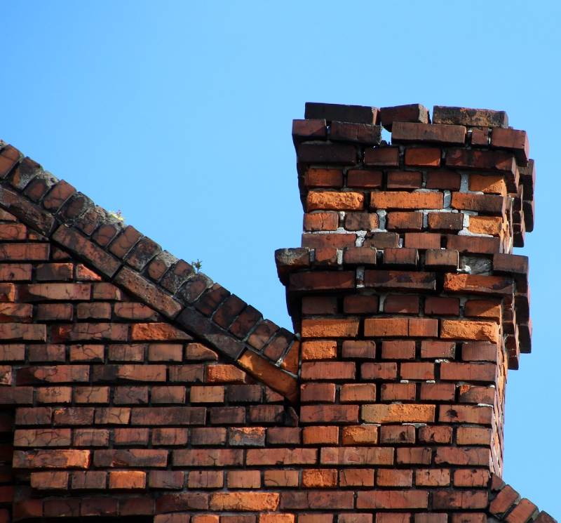 Signs Your Baltimore Home Needs a Chimney Inspection Damaged chimney on an Baltimore home showing cracks and missing mortar